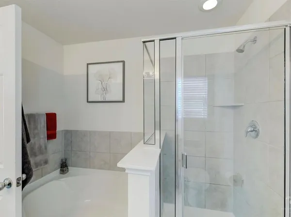 a bathroom with a bathtub and shower
