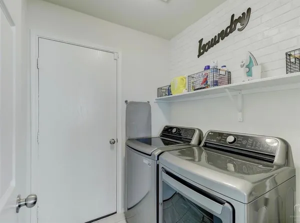 a close up of a utility room with washer and dryer