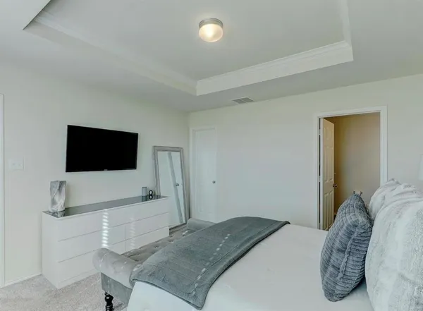 a bedroom with a bed and a flat screen tv