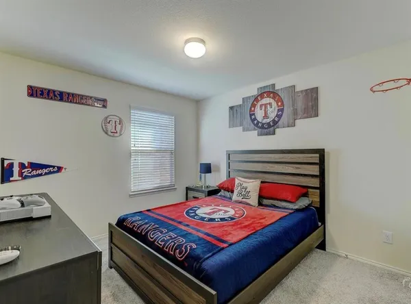 a bedroom with a bed and a desk