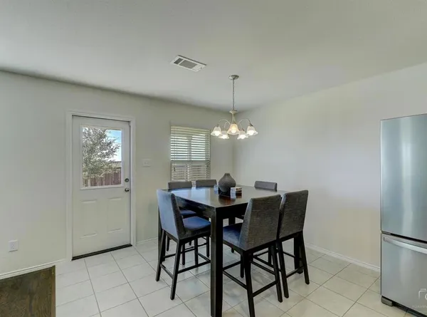 a view of a dining room with furniture and chandelier