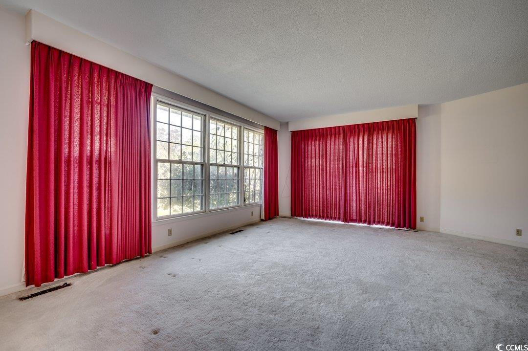 2837 Long Ave Extension Conway, SC 29526 - Photo 13 of 39 Empty room with a textured ceiling and carpet floo