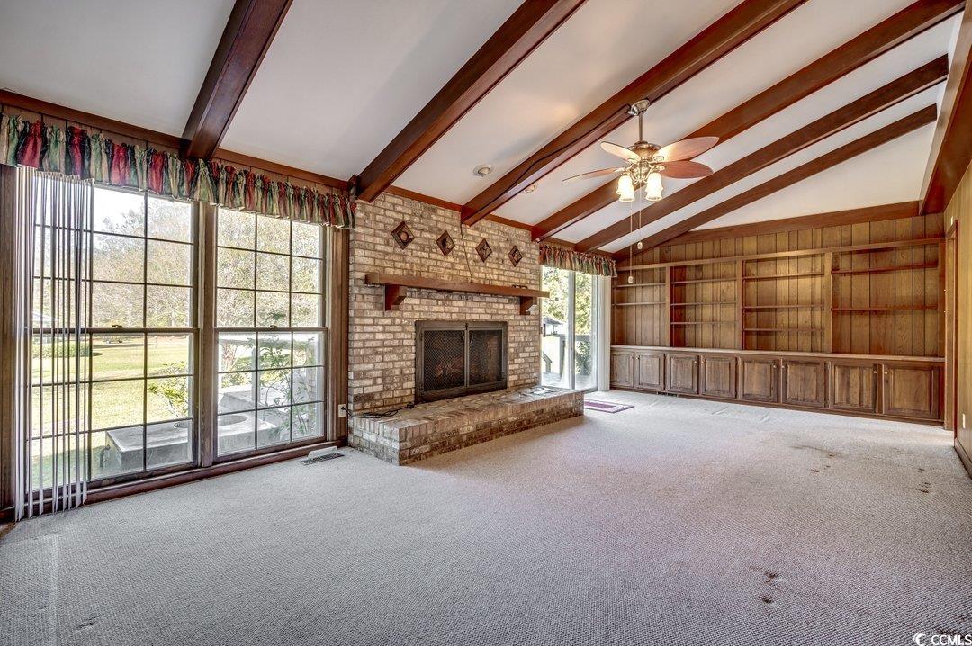 Unfurnished living room featuring carpet flooring,