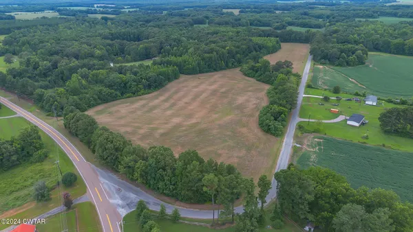 an aerial view of a house with a yard and lake view