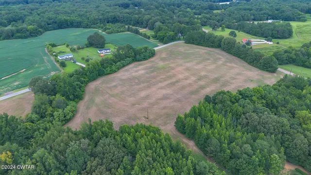 a view of a swimming pool with a yard