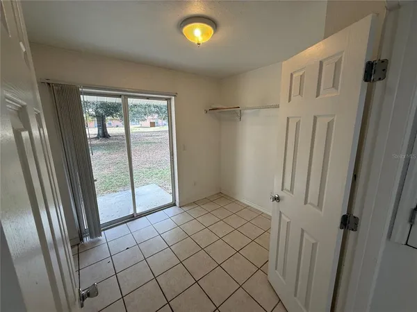 a view of an empty room and closet area