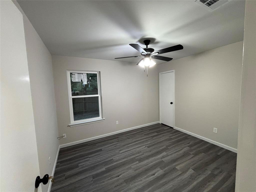 8455 Sugarberry Road Dallas, TX 75249 - Photo 11 of 18 wooden floor in an empty room with a window