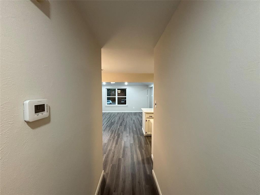 8455 Sugarberry Road Dallas, TX 75249 - Photo 13 of 18 a view of a house with wooden floor