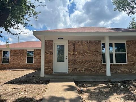 8455 Sugarberry Road Dallas, TX 75249 - Photo 2 of 18 a front view of a house with garden