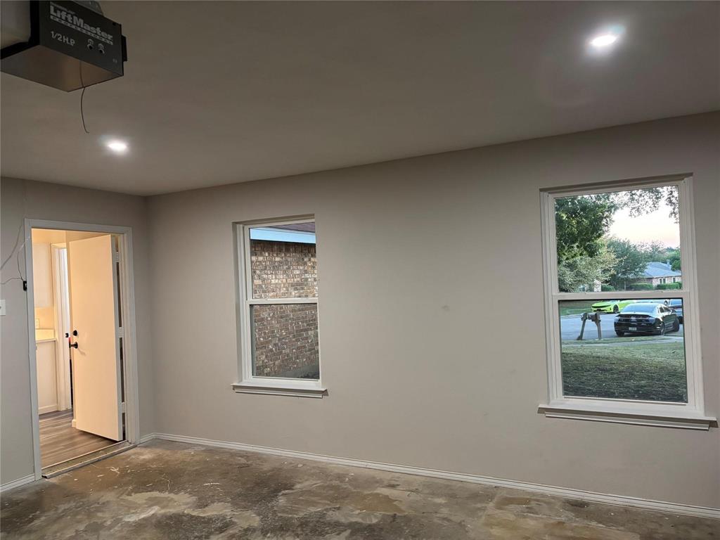 8455 Sugarberry Road Dallas, TX 75249 - Photo 4 of 18 an empty room with a window