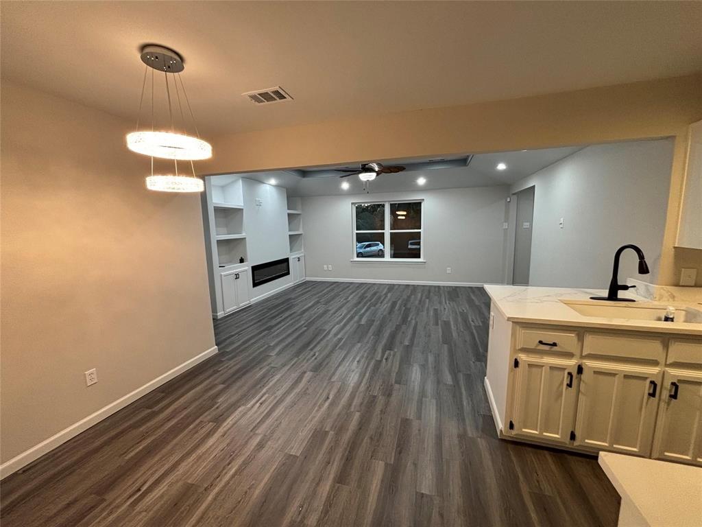 8455 Sugarberry Road Dallas, TX 75249 - Photo 6 of 18 a bathroom with a sink and a mirror