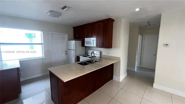 a kitchen with a sink counter top space and appliances