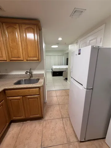 a white refrigerator freezer sitting inside of a kitchen