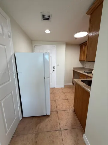 a view of a storage & utility room with a stove fridge
