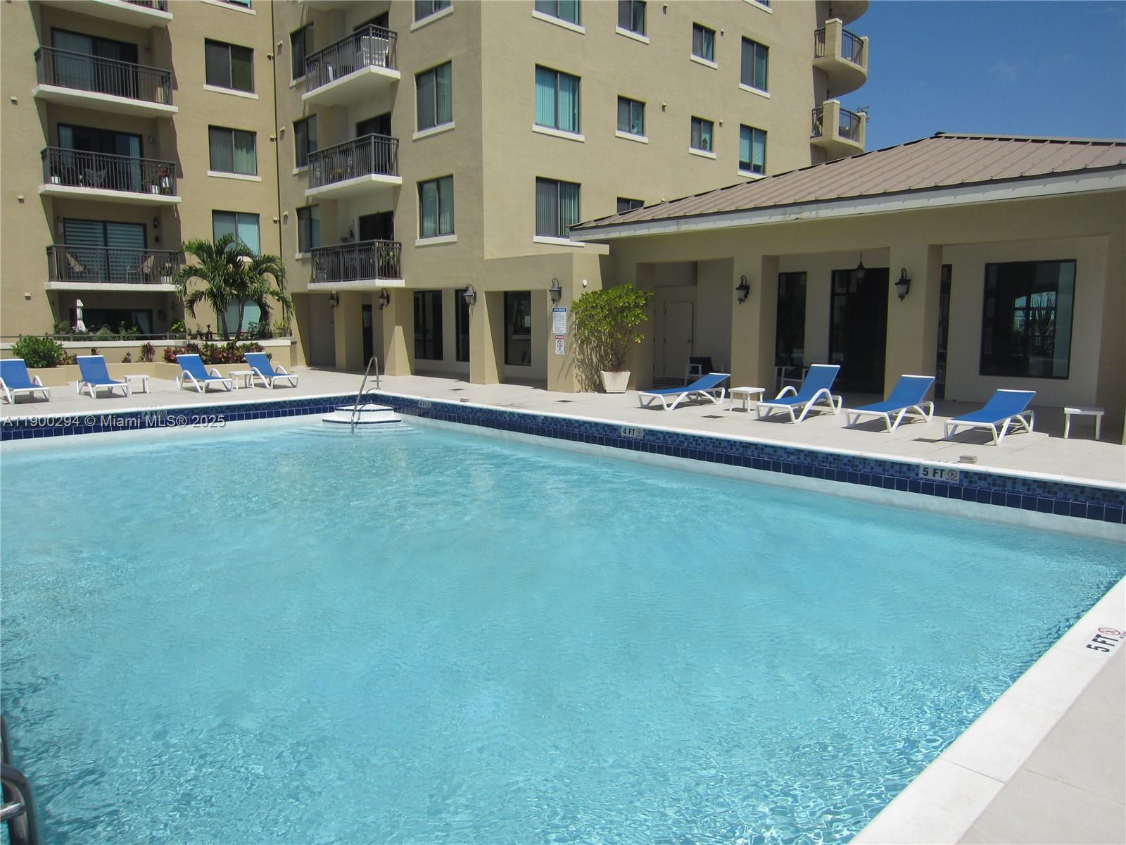 4242 Northwest 2nd Street, Unit 1613 Miami, FL 33126 - Photo 17 of 30 a front view of building with outdoor seating and barbeque oven