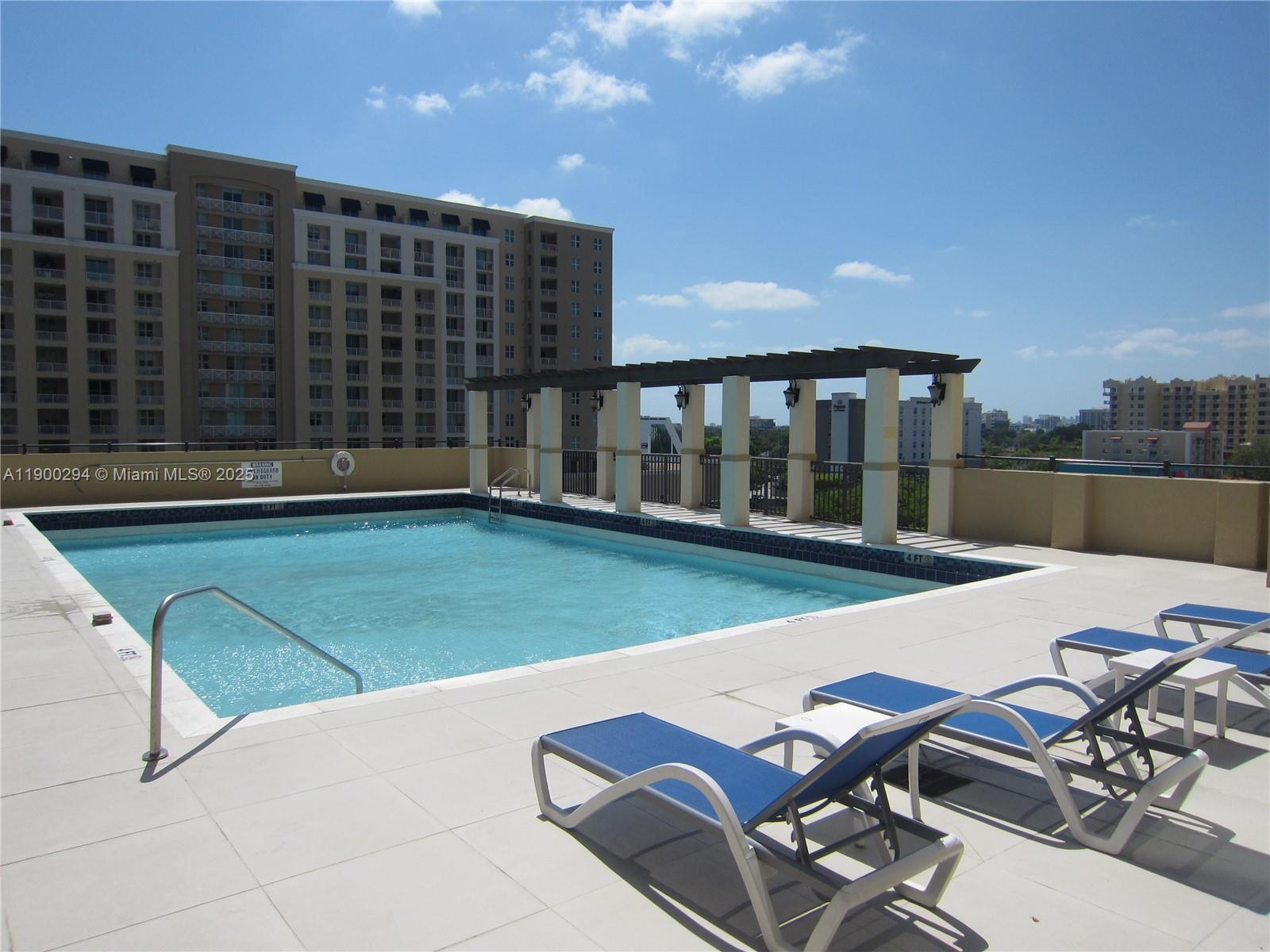 4242 Northwest 2nd Street, Unit 1613 Miami, FL 33126 - Photo 19 of 30 a view of a patio with a table and chairs