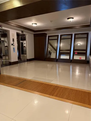 a view of an empty room with glass door and a window