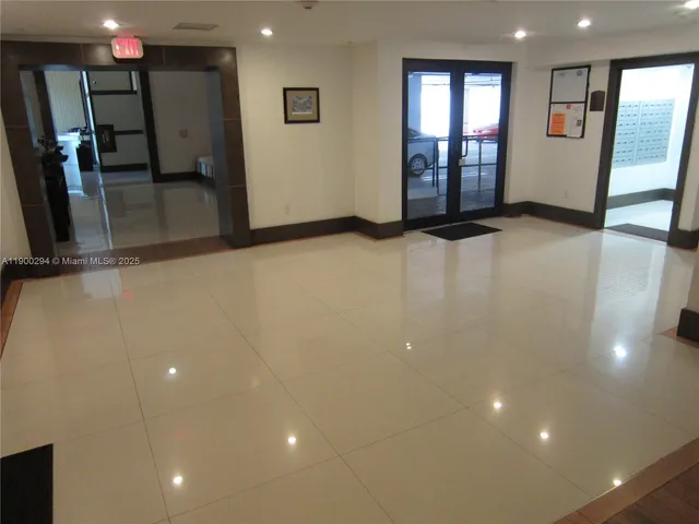 a living room with furniture and large windows