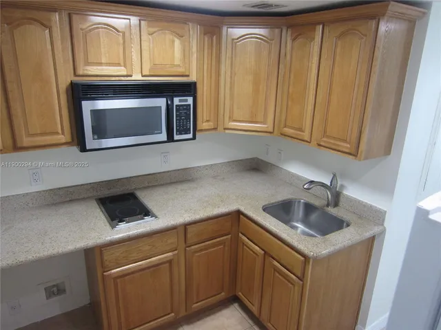 a kitchen with a sink and a microwave