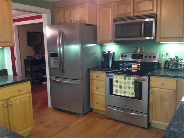 26 Ronaele Road Medford, MA 02155 - Photo 4 of 9 a kitchen with stainless steel appliances granite countertop a refrigerator and a stove