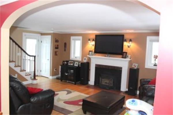 26 Ronaele Road Medford, MA 02155 - Photo 6 of 9 a living room with furniture a flat screen tv and a fireplace