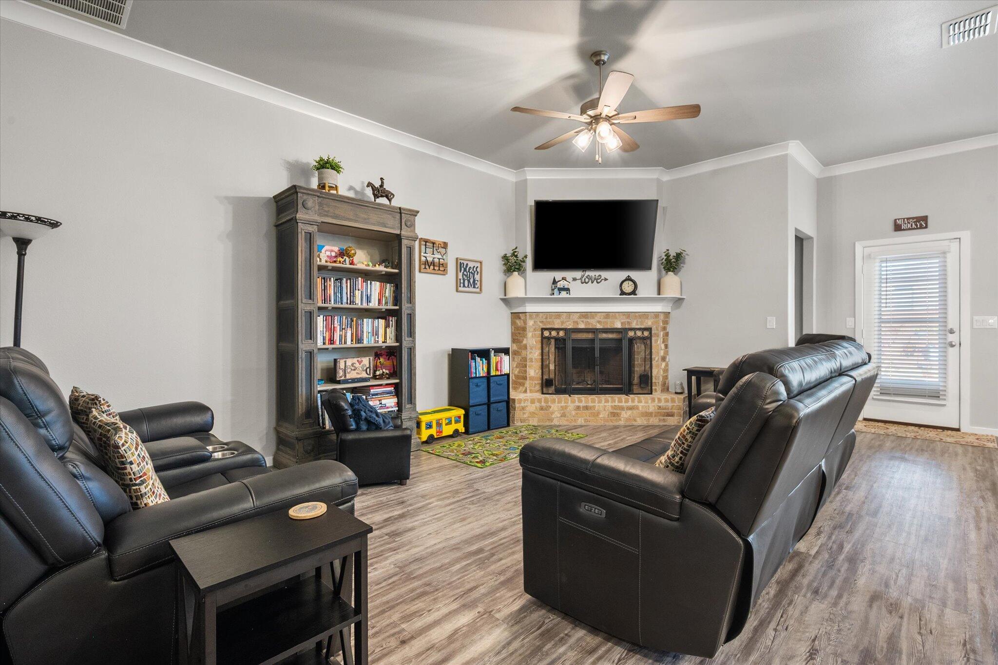 2010 142nd Street Lubbock, TX 79423 - Photo 12 of 33 a living room with furniture and a flat screen tv