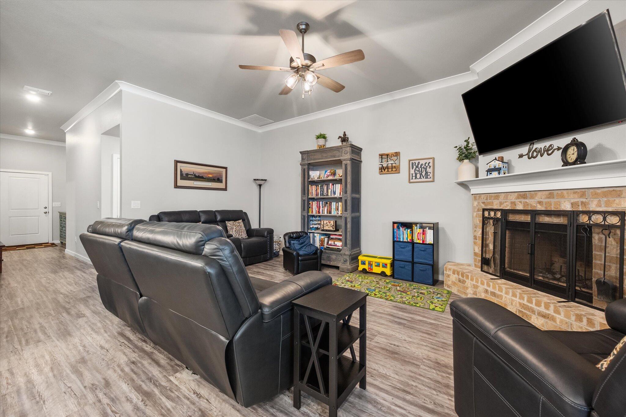 2010 142nd Street Lubbock, TX 79423 - Photo 13 of 33 a living room with furniture and a flat screen tv