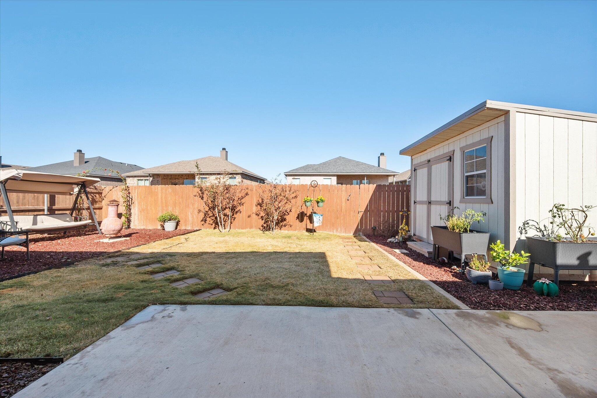 2010 142nd Street Lubbock, TX 79423 - Photo 30 of 33 a view of a house with backyard and sitting area