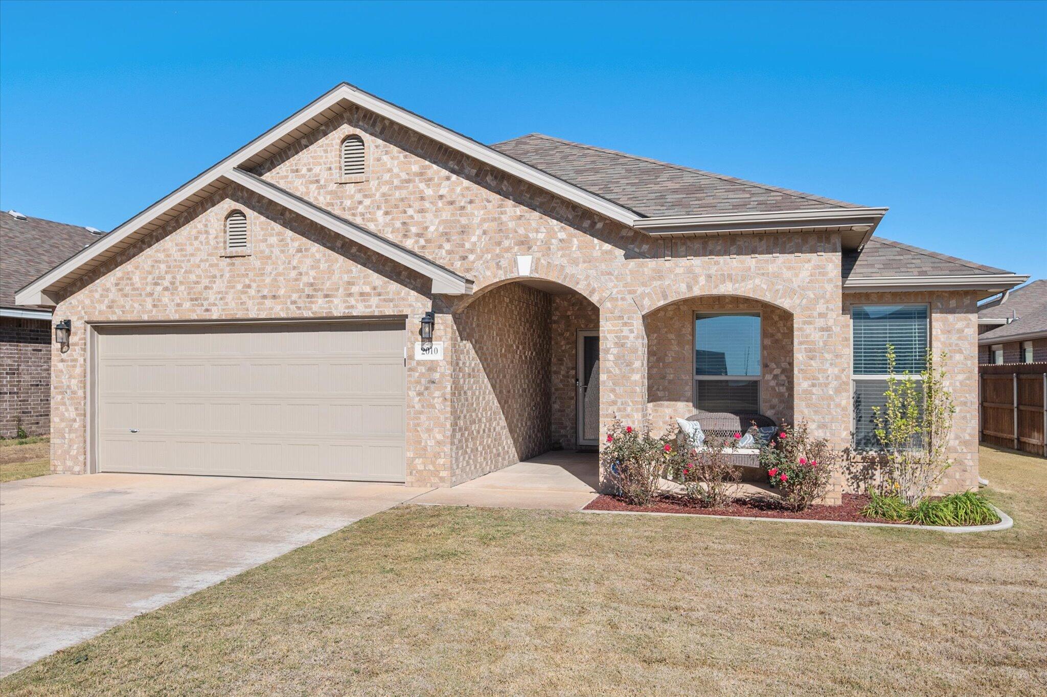 2010 142nd Street Lubbock, TX 79423 - Photo 4 of 33 a front view of a house with a yard