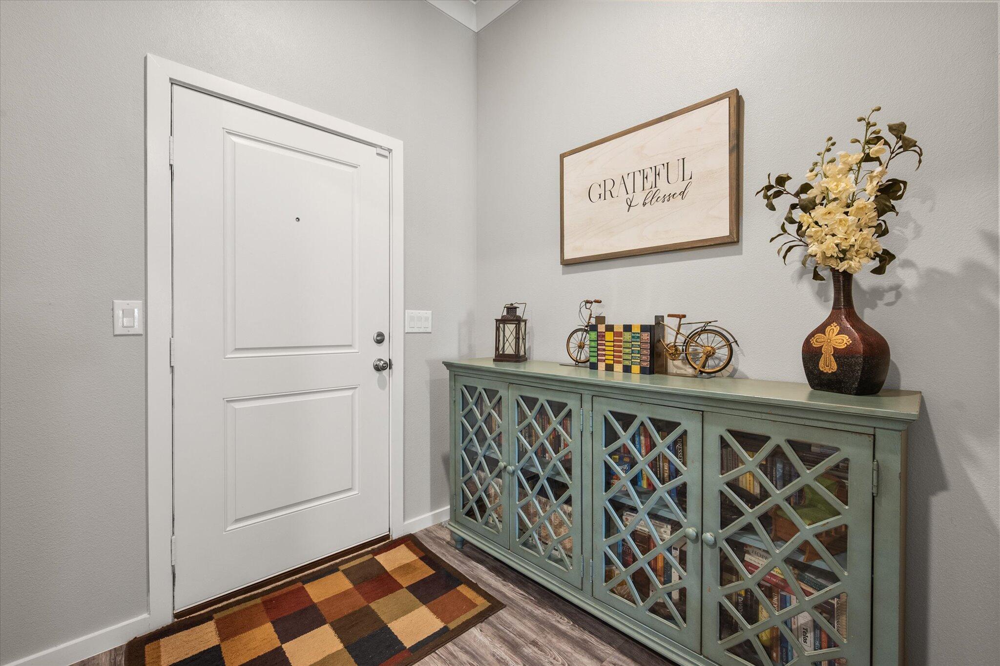 2010 142nd Street Lubbock, TX 79423 - Photo 6 of 33 a view of a hallway with wooden floor and a potted plant