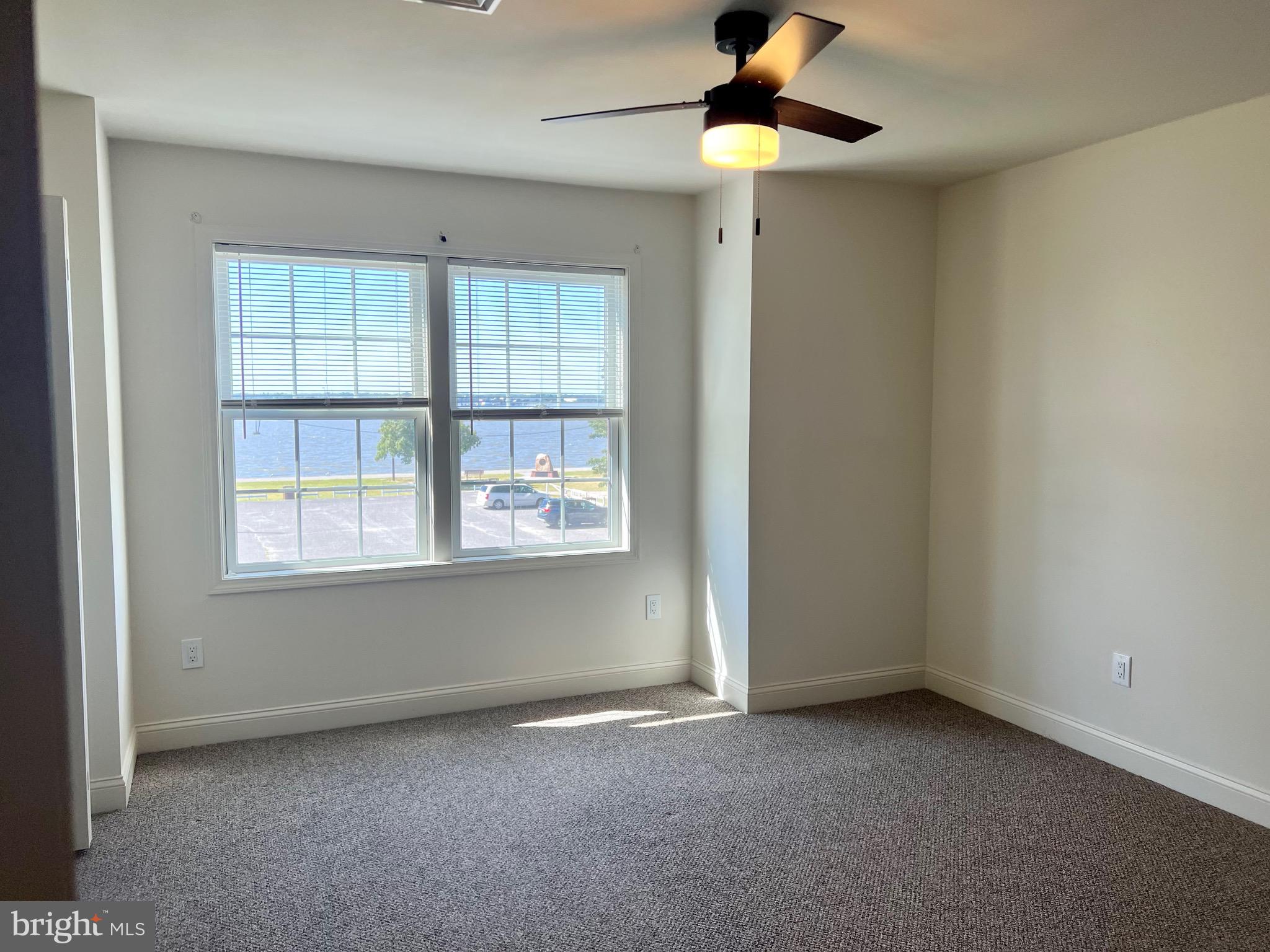 46 West Pittsfield Street Pennsville, NJ 08070 - Photo 11 of 25 an empty room with a window and a fan