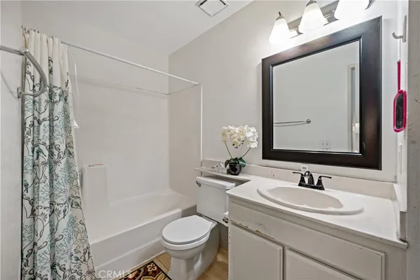a bathroom with a sink toilet a mirror and shower