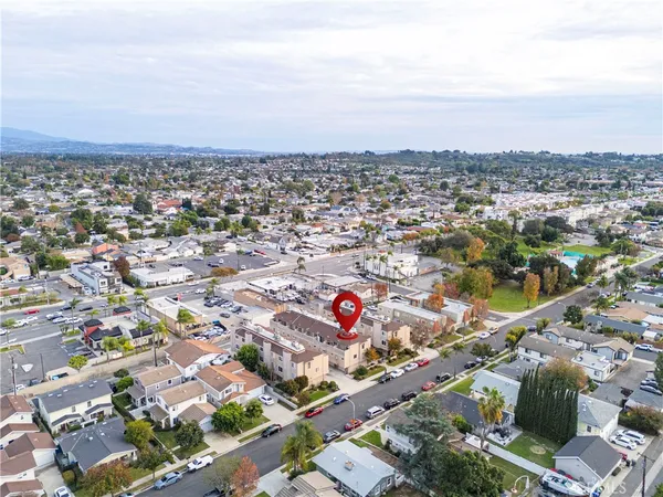an aerial view of residential houses with city view