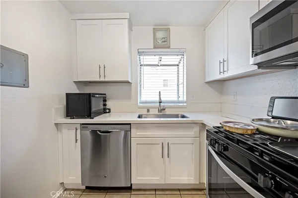 a kitchen with stainless steel appliances a sink stove and microwave