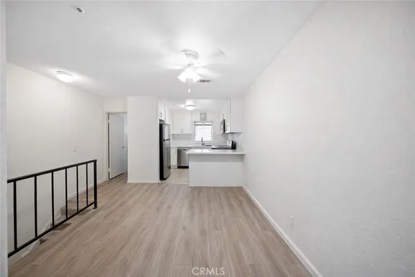 a view of a kitchen with wooden floor