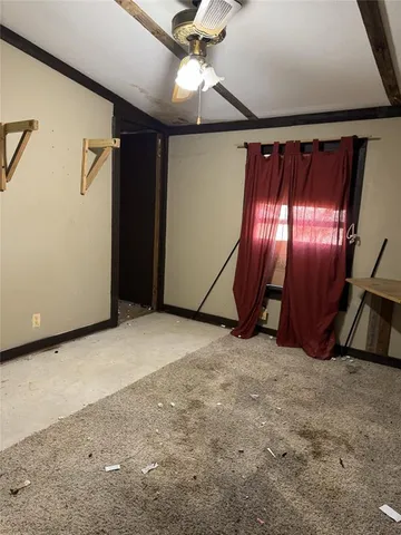 a view of an empty room with a ceiling fan