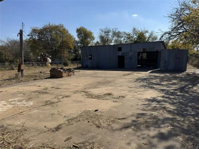 a view of a house with a yard and covered with snow in the background