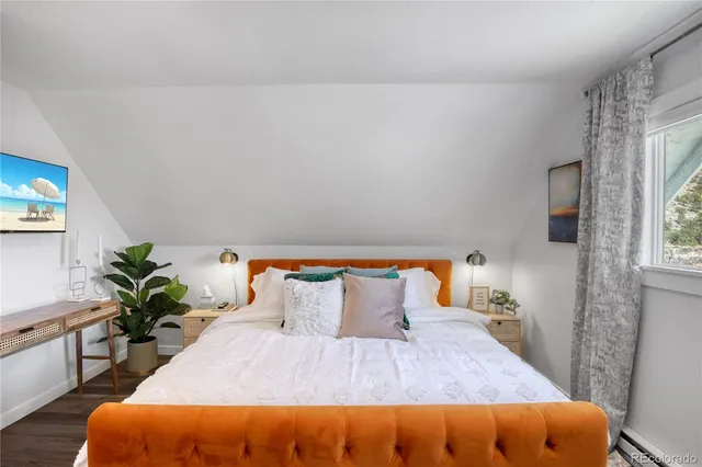 a bedroom with a bed and a potted plant