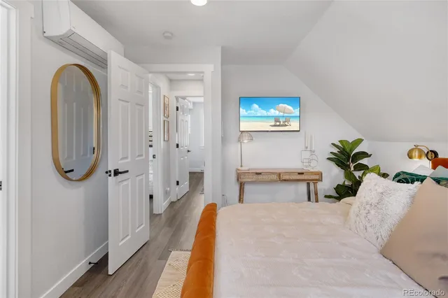 a spacious bedroom with a bed and a table