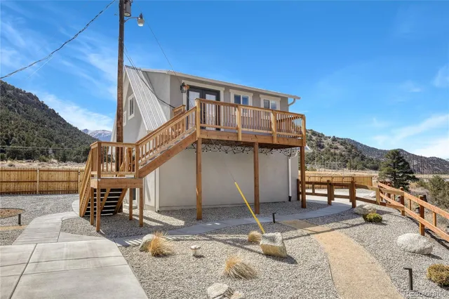 a view of a house with wooden deck