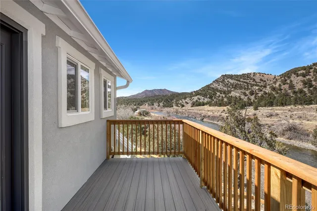 a view of a balcony with wooden fence and floor