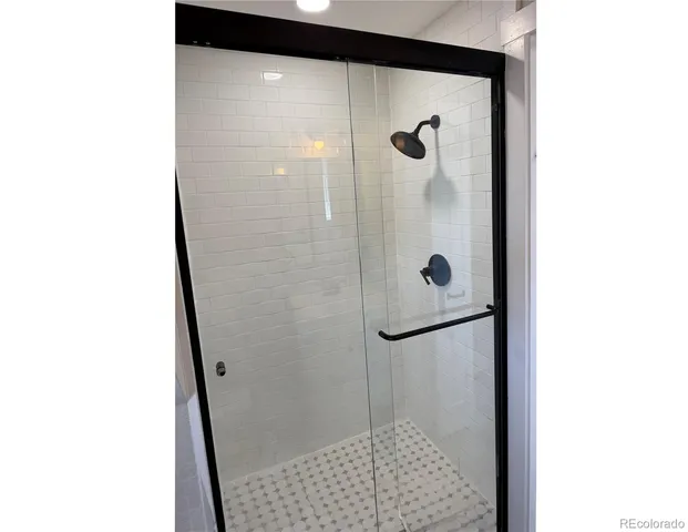 a bathroom with a glass shower door