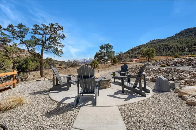 a view of a terrace with furniture and a mountain