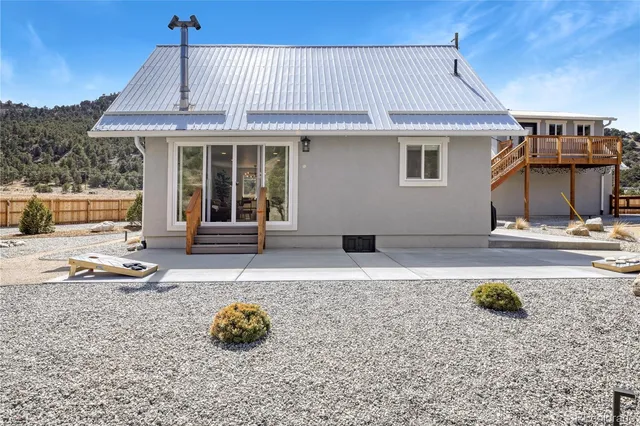 a backyard of a house with barbeque oven table and chairs