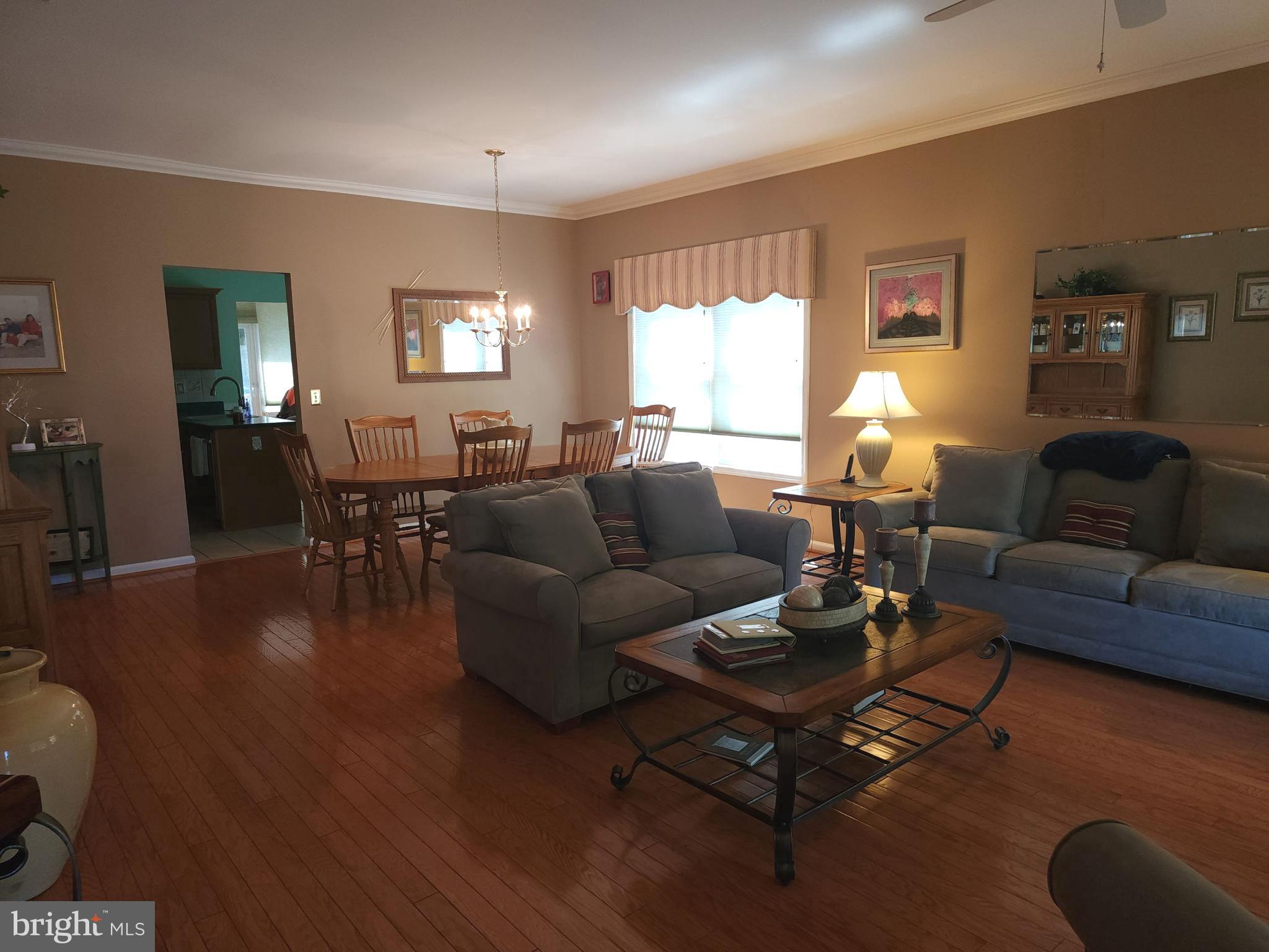 33 Sunset Lane Columbus, NJ 08022 - Photo 22 of 29 a living room with furniture a dining table and wooden floor