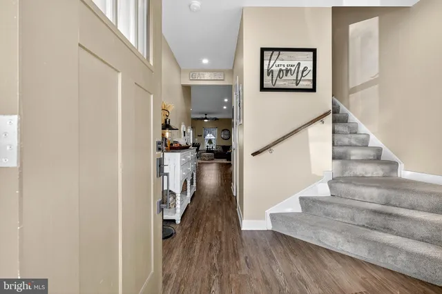 a view of a room with furniture and wooden floor