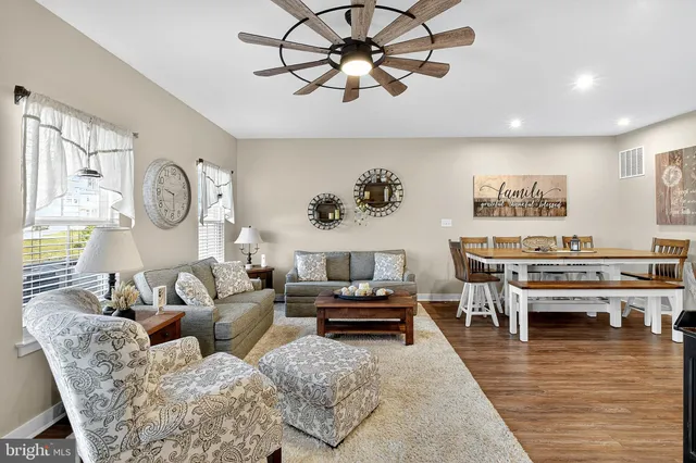a kitchen with refrigerator a stove a sink and chairs