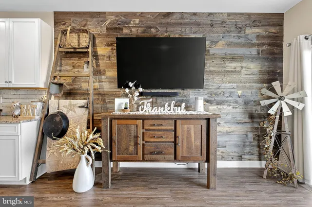 a view of a dining room with furniture a rug and wooden floor