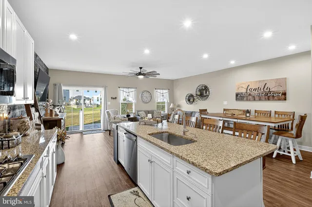 a bathroom with a sink a toilet a mirror and shower curtain