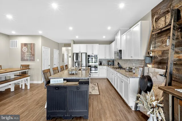 a living room with furniture a flat screen tv and a window